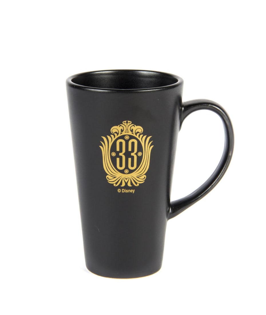 A Club 33 Souvenir Coffee Mug.: (Disneyland, 1990s) A souvenir mug featuring the original logo of Club 33 in Disneyland. Measuring 6" tall and 3.5" in diameter, the ceramic mug is in very good condition with light wear.