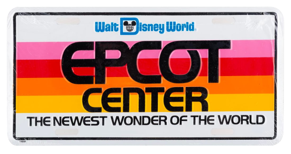 An EPCOT Center Opening Year License Plate.: (EPCOT, 1982) An opening year stamped metal Walt Disney World EPCOT Center license plate featuring the grand opening tag line, "The Newest Wonder of the World." Measuring 6" x 12", the sealed license 