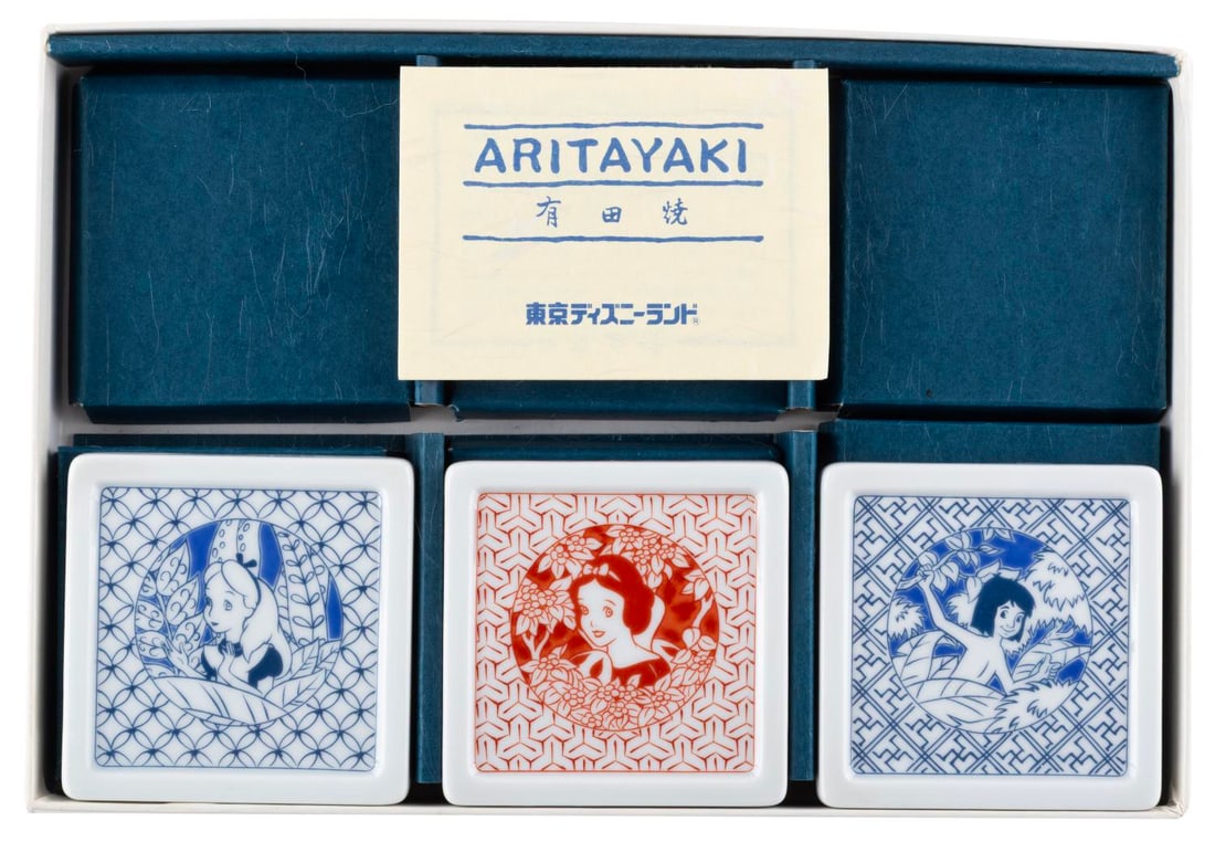 A Tokyo Disneyland Aritayaki Plate Set.: (Tokyo Disneyland, 1980s-90s) A set of three square Aritayaki ceramic plates originating from Tokyo Disneyland. The plates feature Alice from "Alice in Wonderland" in blue, Snow White in red, and Mowg