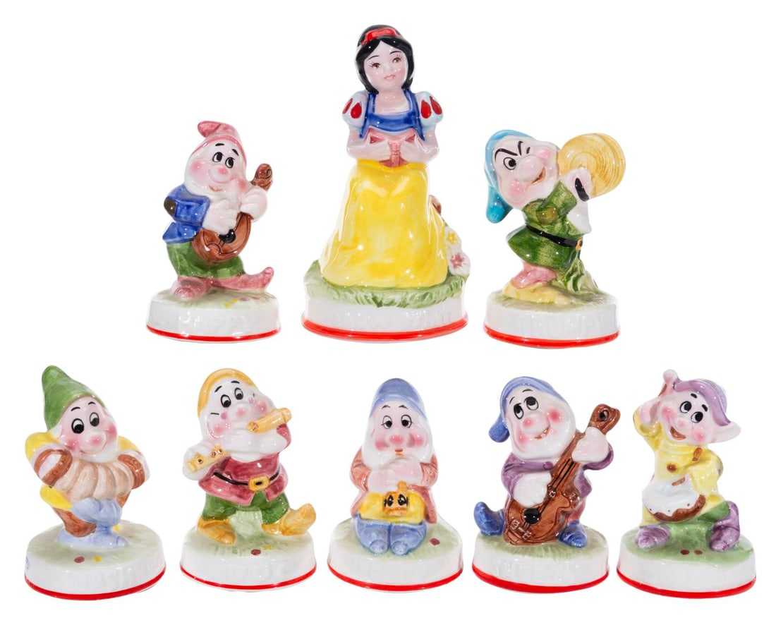 A Set of Tokyo Disneyland "Snow White" Music Boxes.: (Tokyo Disneyland, 1980s) A rare complete set of eight "Snow White and the Seven Dwarfs" ceramic music boxes. When the keys are turned, the figurines rotate and play "Heigh Ho," "Someday My Prince Wil