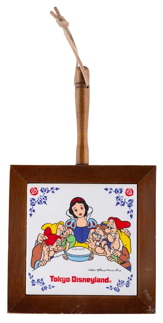 A Tokyo Disneyland Snow White and the Seven Dwarfs Trivet.: (Tokyo Disneyland, 1980s) A souvenir wooden and tile trivet from Tokyo Disneyland featuring "Snow White and the Seven Dwarfs." Measuring 5.75" x 9.5" x 0.75", the souvenir is in good condition with sm