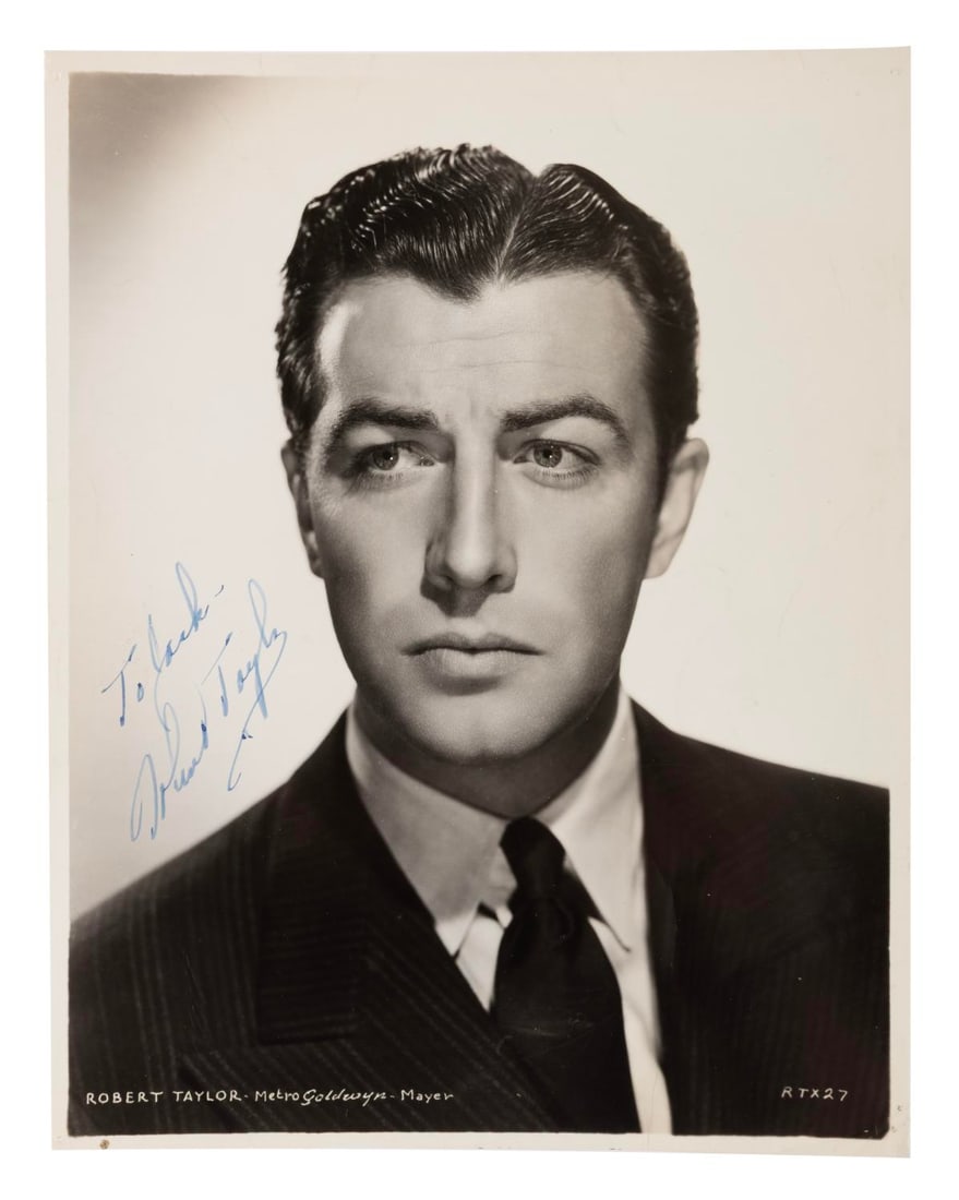 A Robert Taylor Signed Photograph.: (MGM, 1930s/40s) An autographed photo of actor Robert Taylor, known as "the man with the perfect profile." Taylor signed in blue ink with a dedication to Jack. The 8" x 10" signed photo is in very