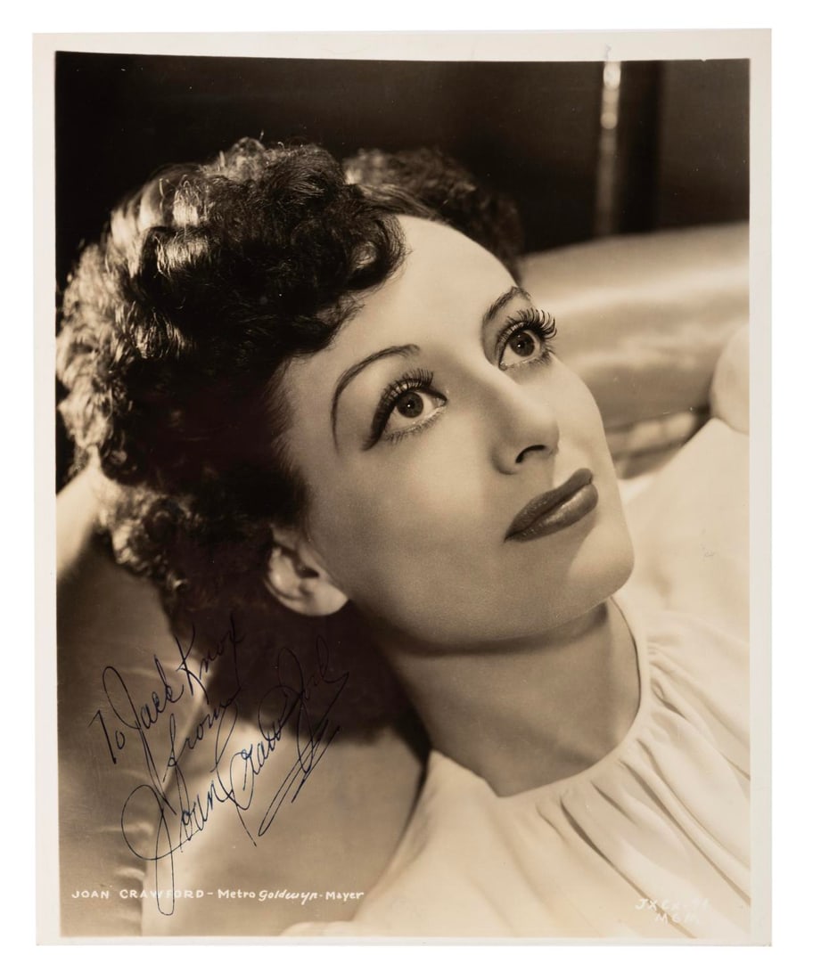 A Joan Crawford Signed Photograph.: (MGM, 1930s/40s) An autographed photo of Joan Crawford, signed with a dedication. The 8" x 10" photo is in very good condition with light handling wear and typical toning from age.