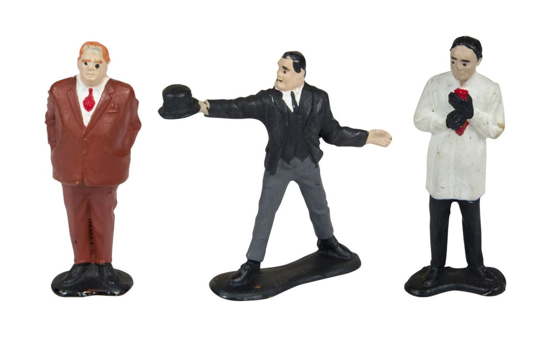 A Trio of Early James Bond Villain Figures.: (Gilbert, 1960s) Three James Bond villain figurines, including Dr. No, Goldfinger, and Oddjob. Measuring 3.25" tall each, the hand-painted figurines are in good to very good condition with scuffs,