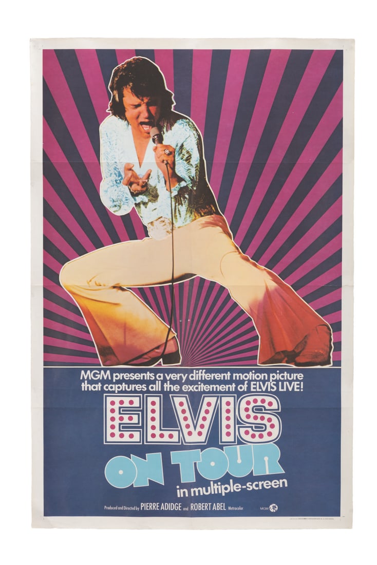 An "Elvis on Tour" One-Sheet.: (MGM, 1972) A one-sheet for the Elvis concert film, "Elvis on Tour." Measuring 27" x 41", the poster is in good condition with a 3" tear along one of the vertical creases, edge wear, creasing, staple