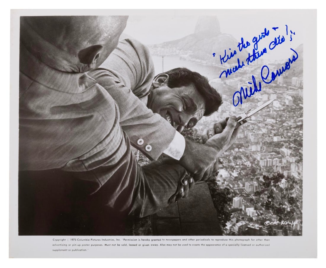A Mike Connors Autographed Photograph.: (Columbia, 1975) An autographed photo of actor Mike Connors. Best known for his role as TV?s Mannix, this photo is from his 1966 spy spoof "Kiss the Girls and Make Them Die." Measuring 8" x 10", the