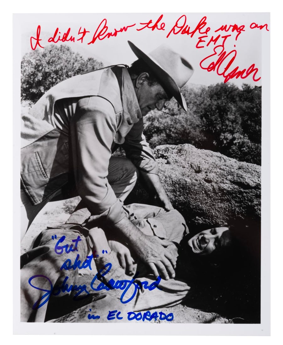 An Ed Asner and Johnny Crawford Signed "El Dorado" Photograph.: (Paramount, 1990s) A photograph from John Wayne?s "El Dorado," signed by actors Johnny Crawford and Ed Asner. Crawford appears in the photo as Luke, and Asner played Bart Jason in the film. Measuring 
