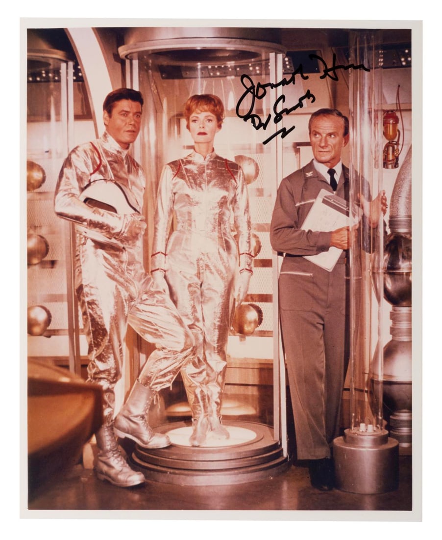 A Jonathan Harris Signed "Lost in Space" Photograph.: (CBS, 1965) A signed photograph of Jonathan Harris as Doctor Smith in "Lost in Space." The 8" x 10" autographed photo is in very good condition with color shift that may be original to printing.