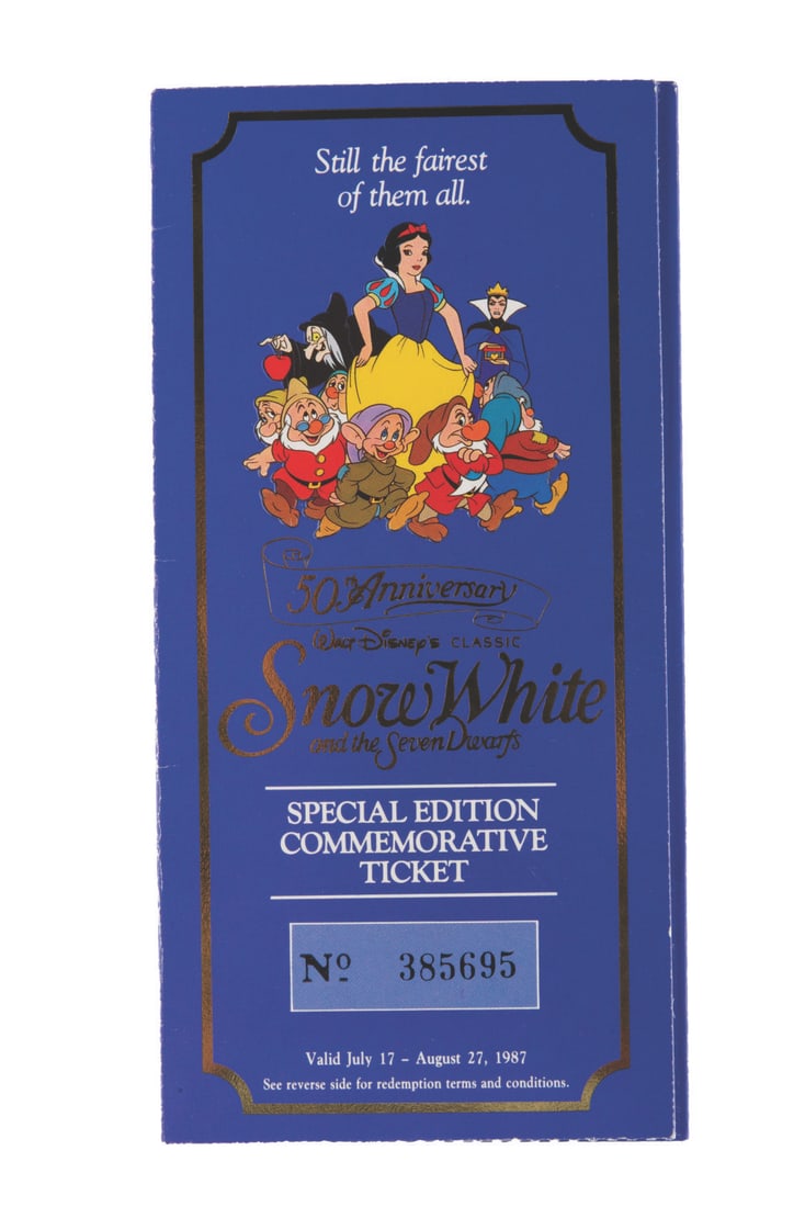 A "Snow White" 50th Anniversary Ticket and Coin.: (Disney, 1987) A commemorative medallion and ticket to the 50th anniversary showing of Walt Disney's "Snow White and the Seven Dwarfs." Numbered 385695, the ticket measures 7" x 3.5" and is in good co