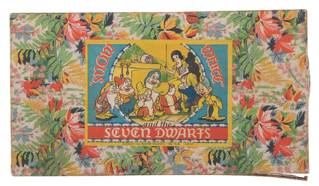 A "Snow White and the Seven Dwarfs" Bisque Figure Set.: (Borgfeldt, 1930s) An eight-piece "Snow White and the Seven Dwarfs" bisque figure set with the rare original floral motif box. Ranging from 2.5" to 3.5" tall, each figure is in very good to fine condi