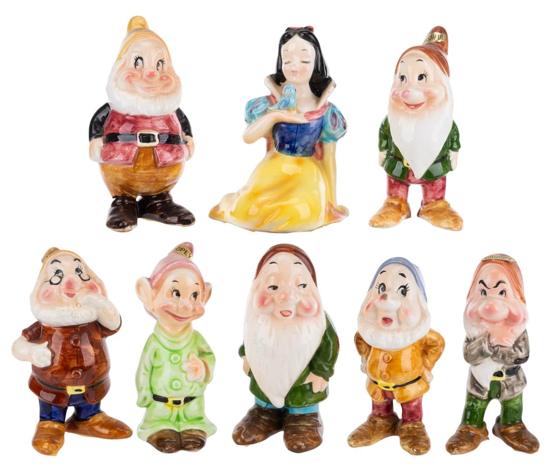 An Enesco "Snow White and the Seven Dwarfs" Ceramic Figure Set.: (Enesco, 1960s) A set of eight ceramic figures of "Snow White and the Seven Dwarfs" by Enesco. Measuring 4.5" to 5" tall, the figurines are in good condition with soiling, spots of glaze loss, adhesiv