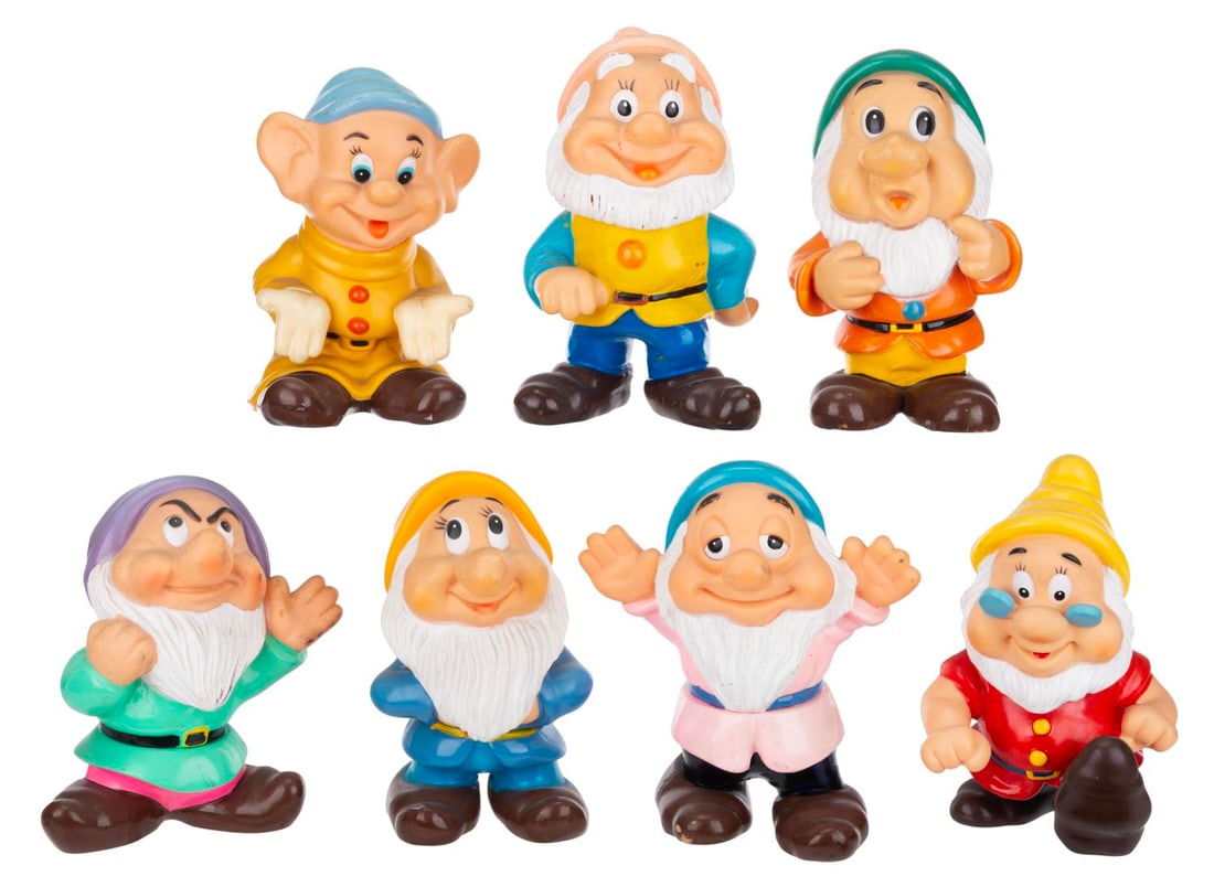 A "Snow White and the Seven Dwarfs" Rubber Figure Set.: (Disney, 1970s) A seven-piece "Snow White and the Seven Dwarfs" play set featuring rubber figurines of each Dwarf. Ranging in size from 5.5" x 4.75" x 7" tall to 7" x 4" x 8.25" tall, the rubber figur