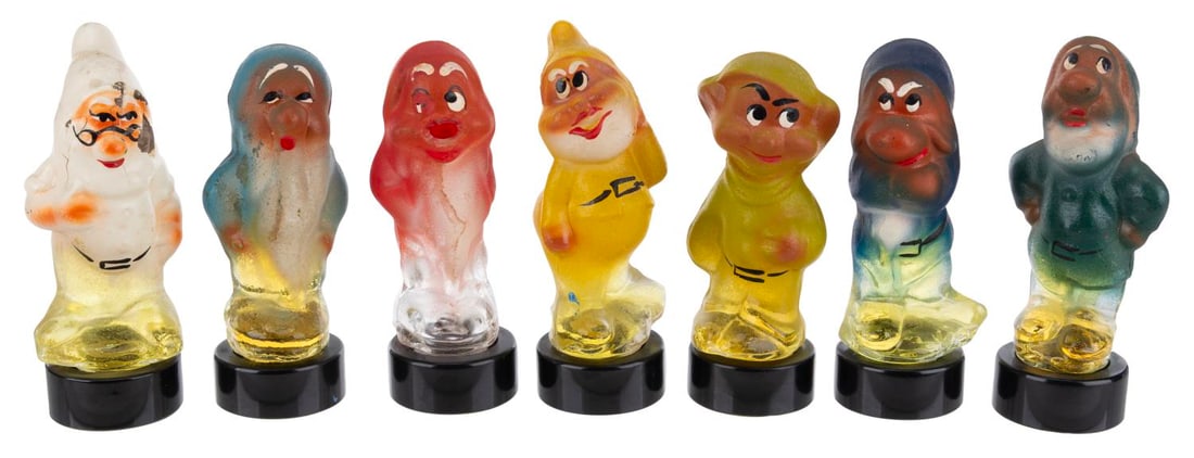 A Set of 1970s "Snow White and the Seven Dwarfs" Perfume Bottles.: (Estonia, 1970s) A "Snow White and the Seven Dwarfs" Eau-De-Cologne set. Featuring a vibrantly hand-painted figural glass bottle of each Dwarf, the perfume was made in Estonia. Measuring