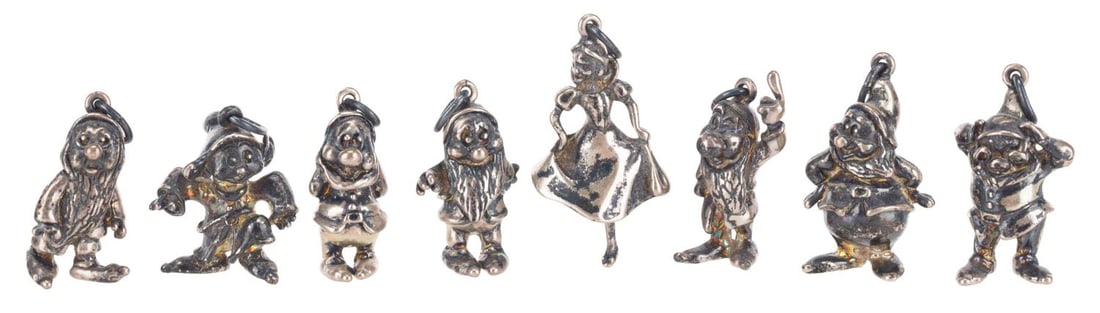 A Set of Sterling Silver "Snow White and the Seven Dwarfs" Charms.: (Disney, 1960s) A set of eight sterling silver "Snow White and the Seven Dwarfs" charms, including Snow White and each Dwarf. Measuring 1" tall each, the charms are in good to very good condition