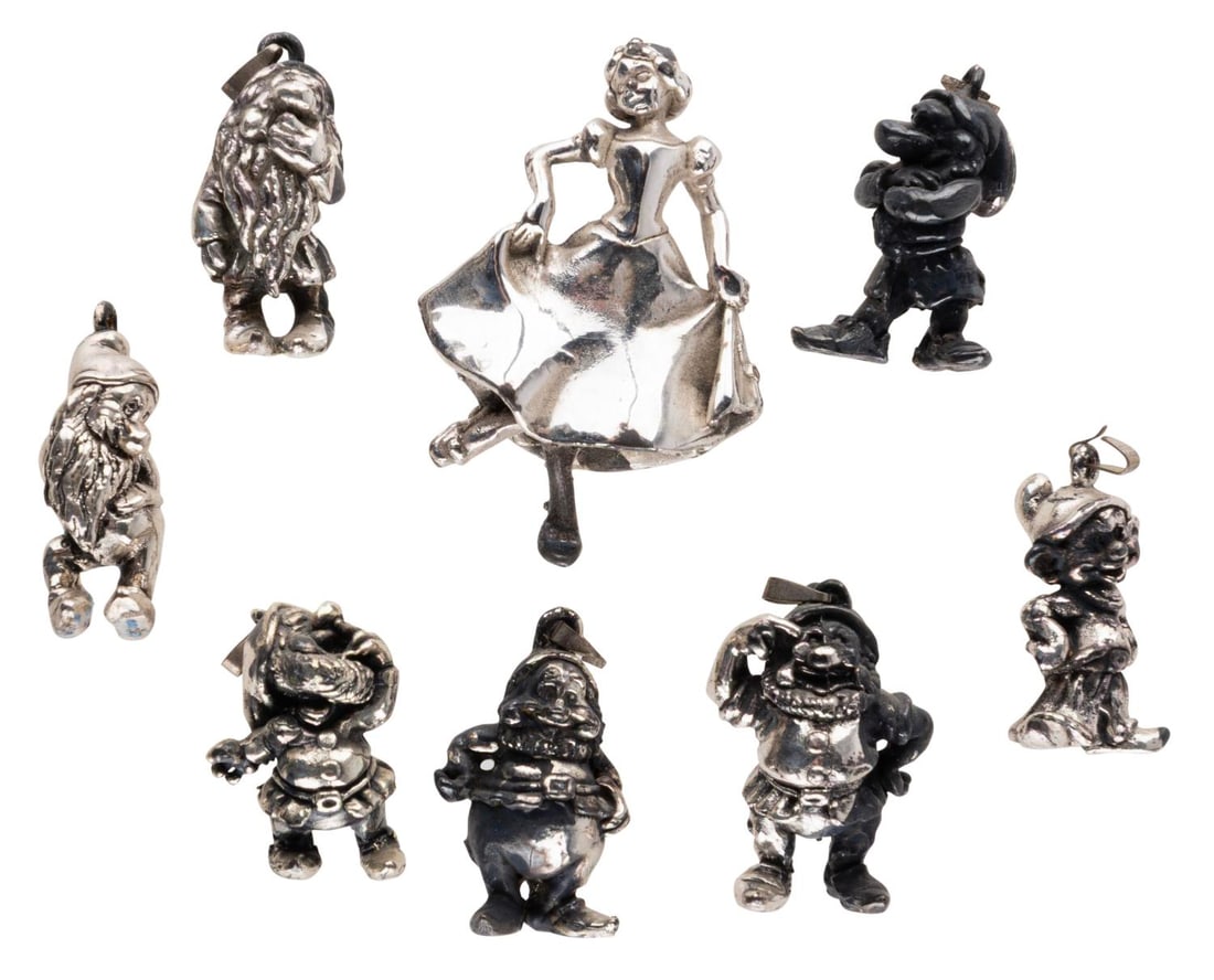 A "Snow White" Sterling Silver Charm Set.: (Designcraft, 1980s-90s) An eight-piece sterling silver "Snow White and the Seven Dwarfs" charm set. The set includes all seven Dwarfs and Snow White stamped with "Sterling DLC." Measuring 1" to