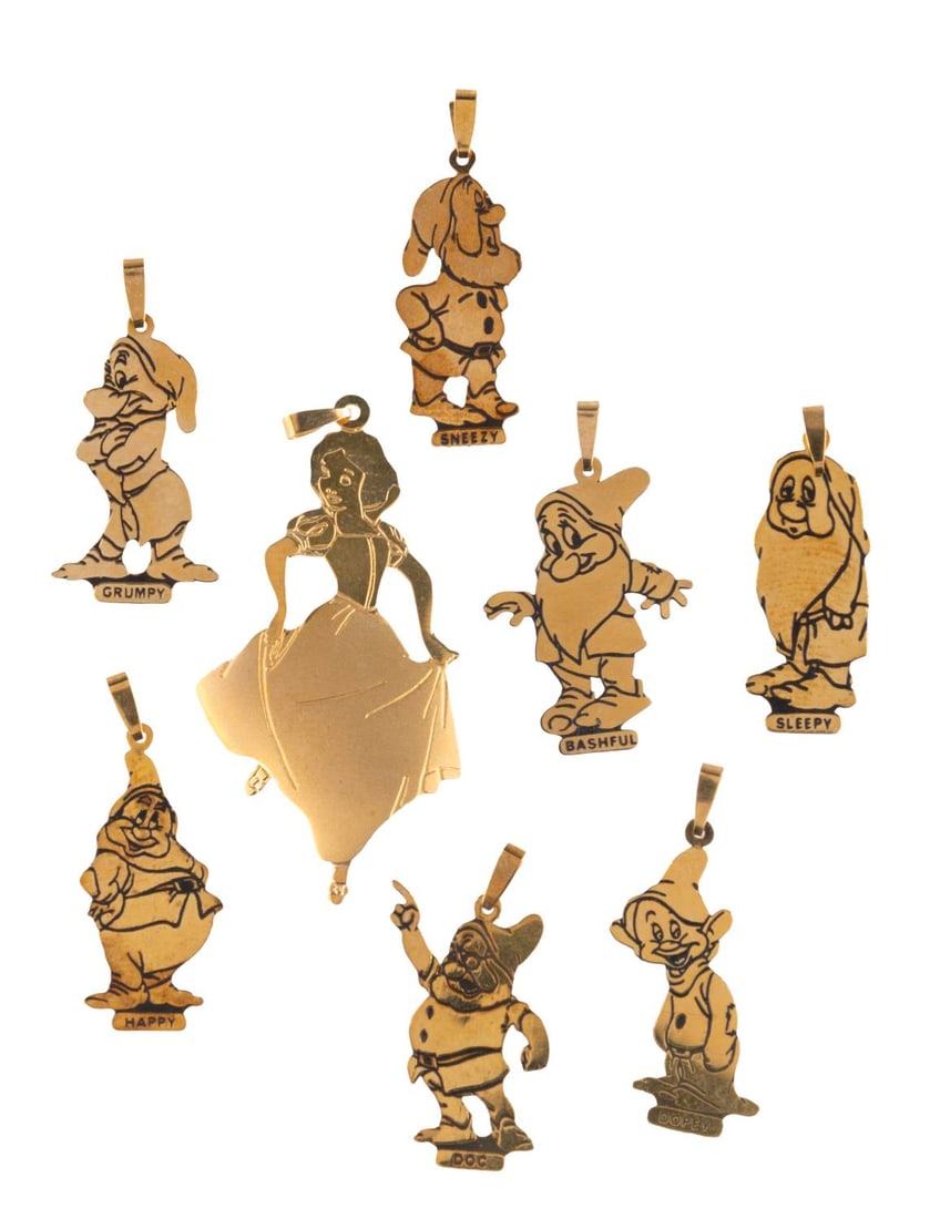 A "Snow White" Gold Charm Set.: (Designcraft, 1980s-90s) An eight-piece gold "Snow White and the Seven Dwarfs" charm set. The set includes all seven Dwarfs and Snow White, each stamped "14k." Measuring 1" to 1.75", the charms are