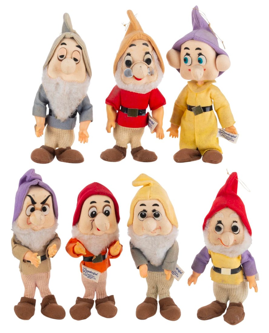 A Set of Gunderful Creations "Snow White" Dwarf Dolls.: (Gund, 1960s) A set of seven Dwarf dolls from "Snow White and the Seven Dwarfs," by Gund. The dolls feature rubber hands and fabric bodies with die-cut felt and hand-drawn features. Measuring 7" to