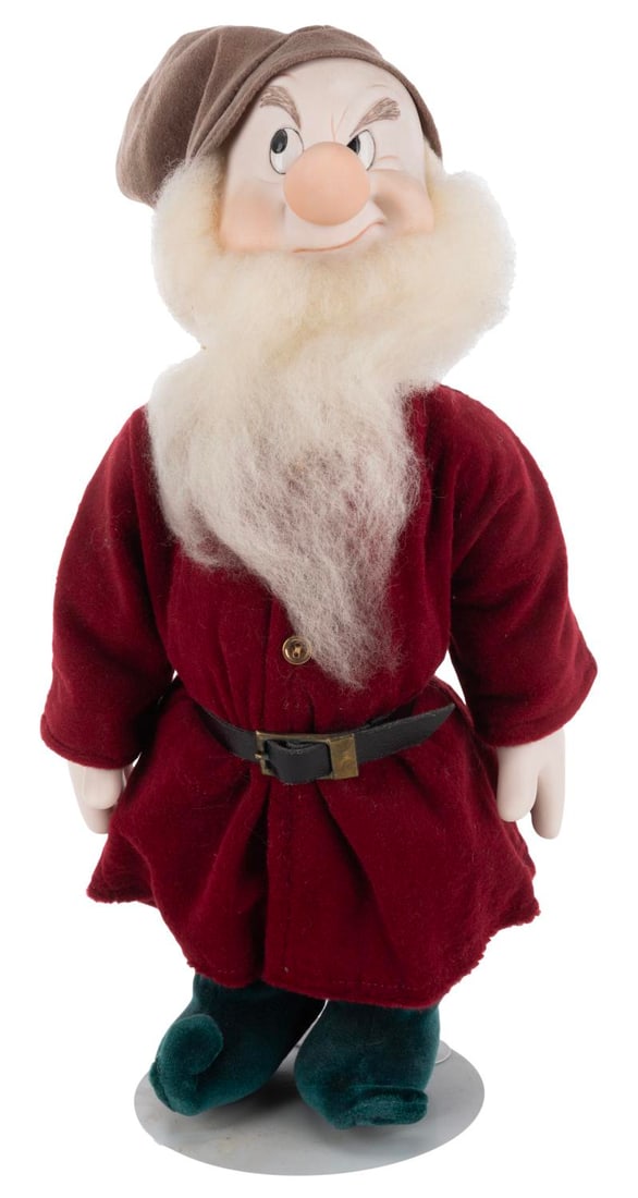 A "Snow White" Grumpy Doll.: (1970s-90s) A doll of Grumpy from "Snow White and the Seven Dwarfs," displayed on a stand by Kaiser of Chicago. Measuring 13" tall and 4.5" in diameter, the doll is in very good condition with light