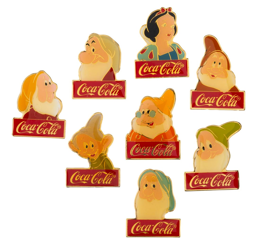 A "Snow White" Coca-Cola Cast Member Pin Set.: (Walt Disney World, 1980s) An eight-piece Cast Member exclusive Coca-Cola "Snow White and the Seven Dwarfs" pin set, celebrating Walt Disney World?s 15th Anniversary. The set is in very good