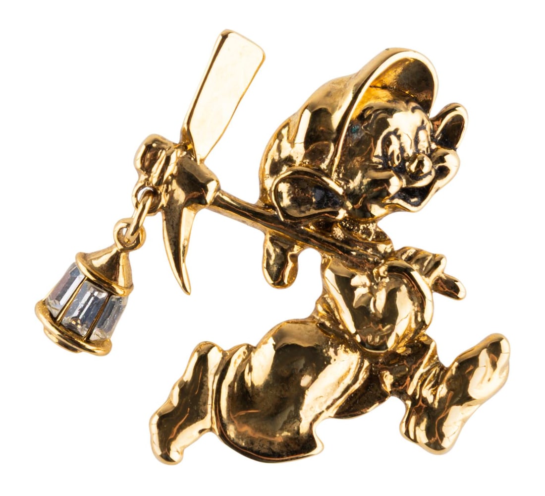 A "Snow White" Dopey Lapel Pin.: (Disney, 2000s) A gold-toned Dopey lapel pin with a hanging lantern crystal charm. Measuring 1.5" long, Dopey is in very good condition with light soiling and tarnishing.