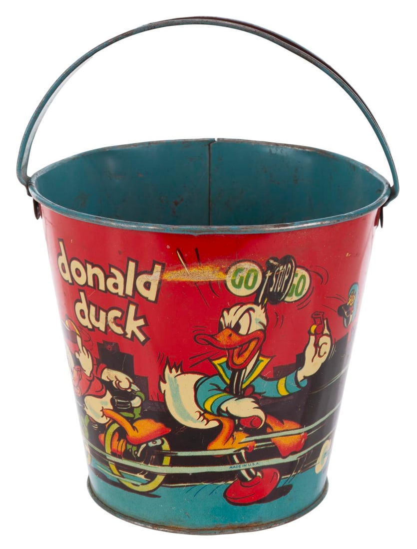 A Donald Duck and Nephews Tin Litho Sand Pail by Ohio Art.: (Ohio Art, 1938) A small tin litho sand pail by Ohio Art Company featuring Donald Duck and his nephews. Measuring 5.75" in diameter x 7" tall including handle, the toy displays in good condition with