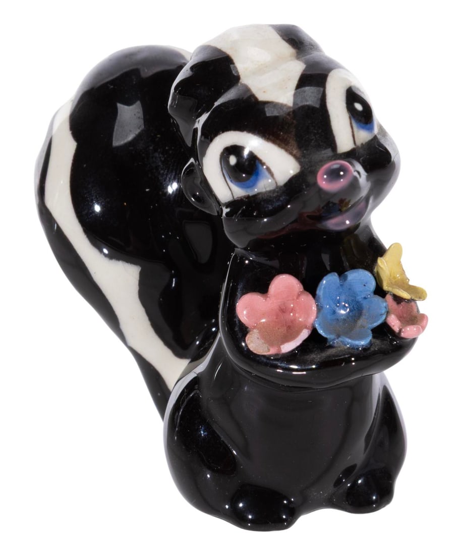 A "Bambi" Flower Ceramic Figurine by Hagen Renaker.: (Hagen-Renaker, 1950s) A rare painted glazed ceramic figurine of Flower from "Bambi" produced in the 1950s by Hagen Renaker. Known for their line of miniature figurines, they also produced a small