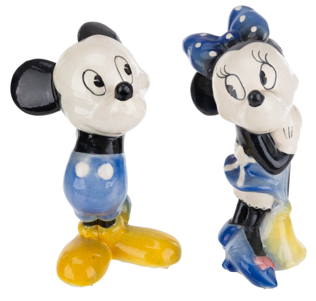 A Pair of 1940s Mickey and Minnie Figurines.: (American Pottery, 1940s) A pair of Mickey and Minnie Mouse ceramic figurines by American Pottery. Both figures measure 6" tall and are in good to very good condition with crazing throughout, spots of
