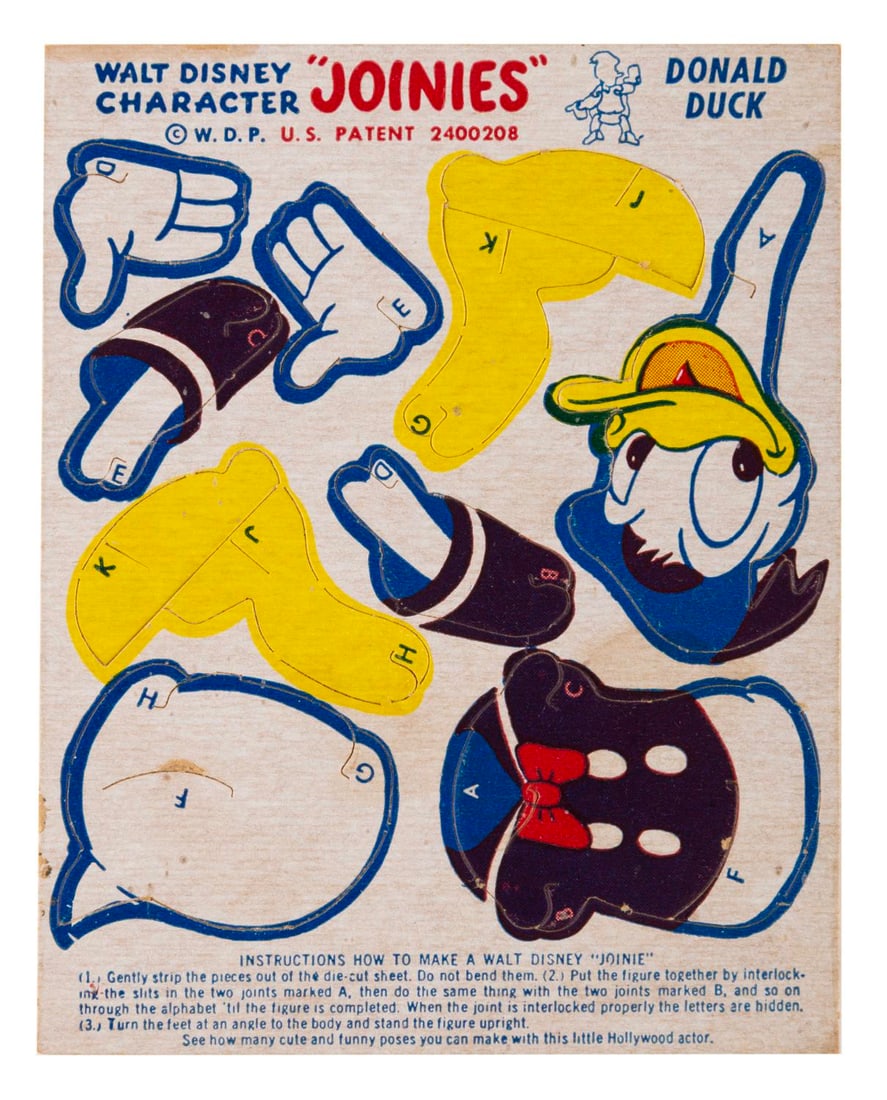 A Donald Duck "Joinie.": (Disney, 1950s-70s) A rare Donald Duck "Joinies" punch-out paper figure. Measuring 3.75" x 4.75", the unpunched Joinie is in good condition with discoloration from age and light wear.