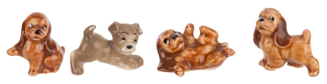 A Set of "Lady and the Tramp" Ceramic Puppy Figurines.: (Shaw, 1950s-70s) A set of four miniature puppy figurines from the ending of "Lady and the Tramp," manufactured by Evan K. Shaw. Measuring .5" to 1" tall, the ceramic figurines are in good condition w