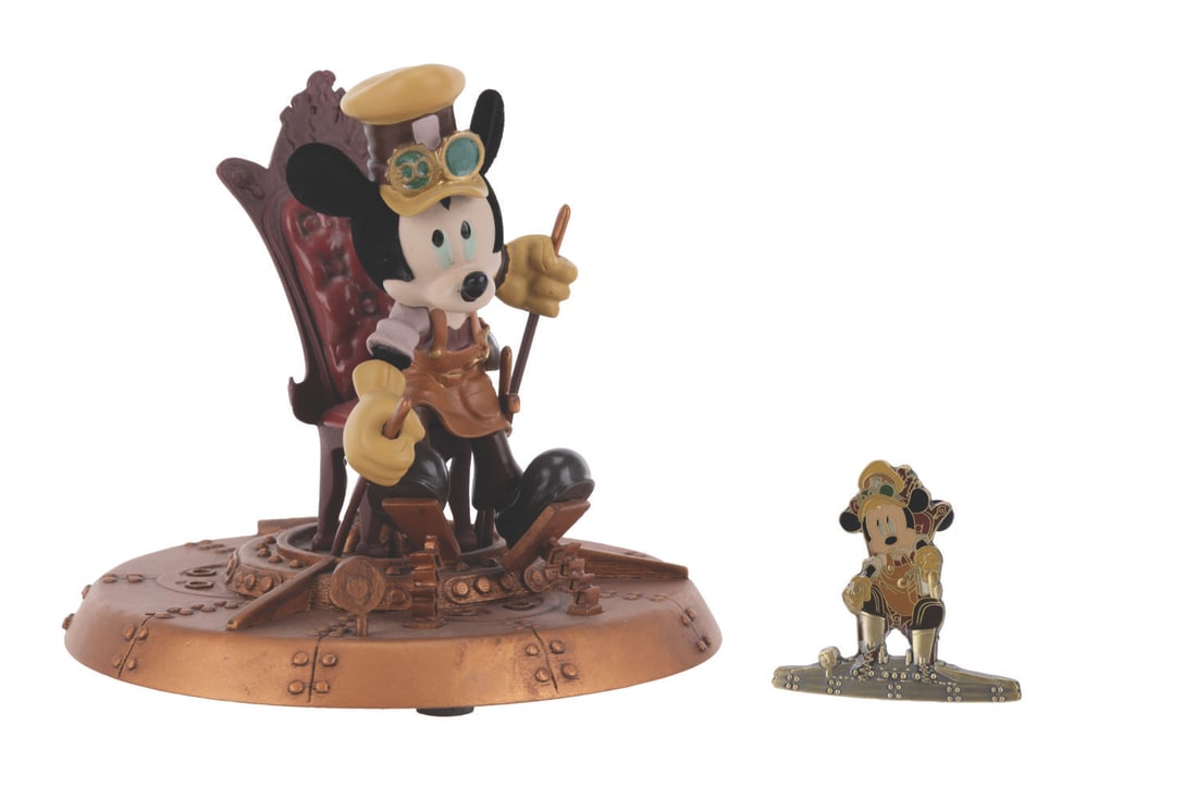A Mickey Mouse Steampunk Figurine and Pin.: (Disney, 2011) A steampunk Mickey Mouse figurine and pin, released in a limited edition of 250. The figurine measures 4.25" tall and 5" in diameter, and the pin 1.75" tall, both in very good