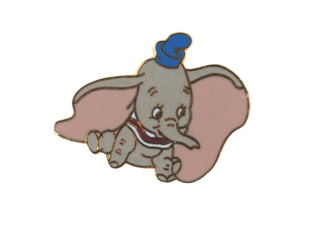 An Early Dumbo Enamel Pin.: (Disney, 1990) A very early pin of Dumbo. Measuring 1" x 0.75" the pin is in very good condition.