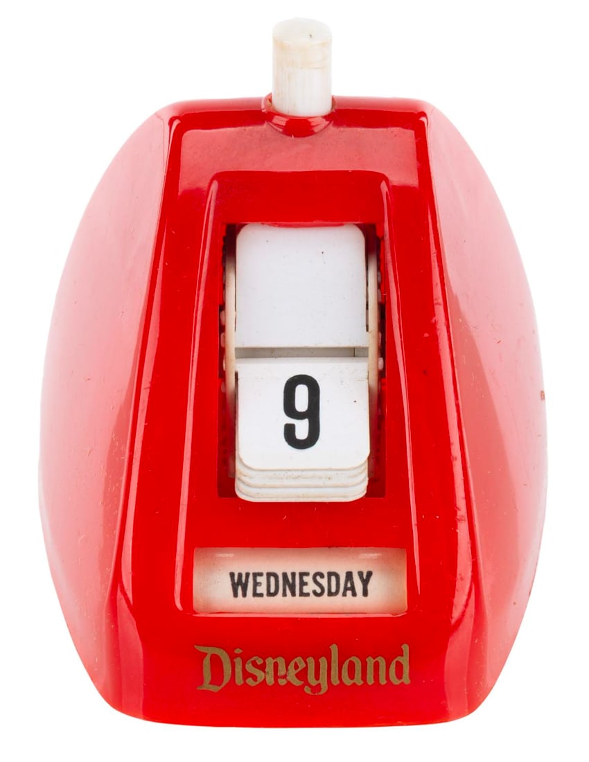 A Disneyland Perpetual/Click-a-Day Calendar.: (Disneyland, 1960s) A plastic Click-a-Day perpetual calendar from Disneyland with the original box. Measuring 2.75" tall, the calendar is in very good condition with light wear from age, and the box