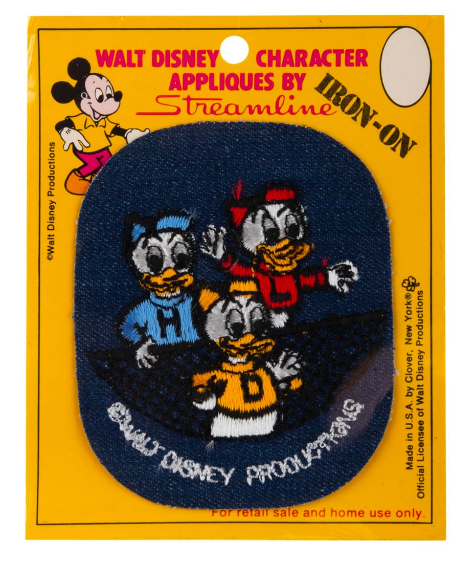 A Donald?s Nephews Iron-On Patch.: (Streamline, 1960s-70s) A Walt Disney Character Iron-On Applique of Donald Duck?s nephews, Huey, Dewey, and Louie. The patch is in fine condition sealed on the original card.