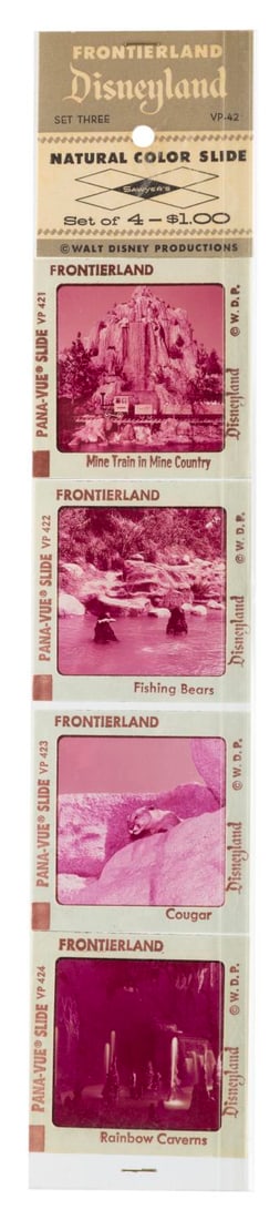 A Disneyland Frontierland Pana-Vue Slide Set.: (Sawyer’s, 1970s) A set of four Frontierland Pana-Vue slides in the original sleeve. Included are slides of the Mine Train, Fishing Bears, a cougar, and the Rainbow Caverns. Measuring 2” x