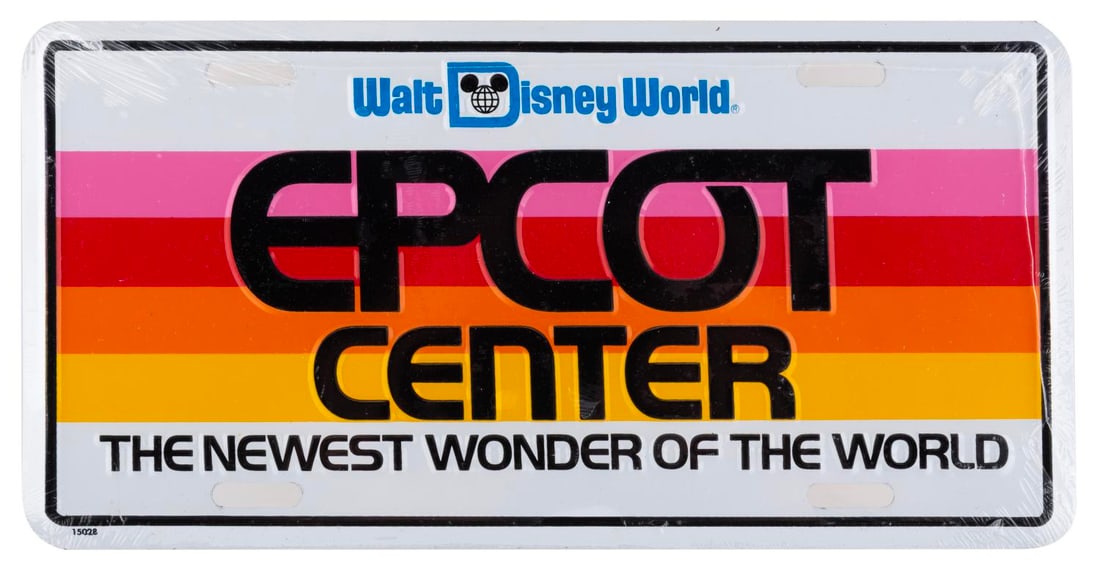 An EPCOT Center Opening Year License Plate.: (EPCOT, 1982) An opening year stamped metal Walt Disney World EPCOT Center license plate featuring the grand opening tag line, "The Newest Wonder of the World." Measuring 6" x 12", the sealed license