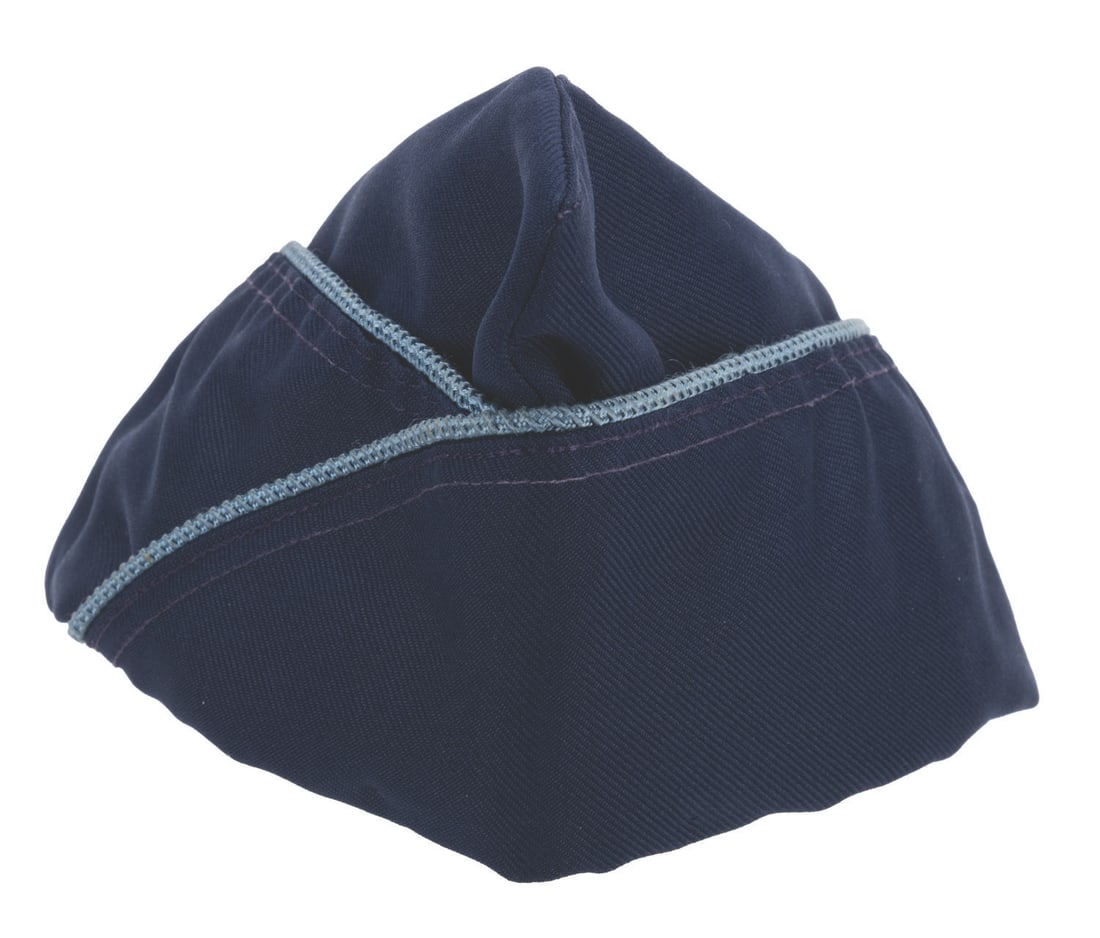 An EPCOT Garrison Style Flight Cap.: (EPCOT, 1980s-2000s) A dark blue garrison-style cap worn by Cast Members working at EPCOT. The cap was likely used in a flying or aviation-based attraction. Marked a size 7 ?, the cap is in very