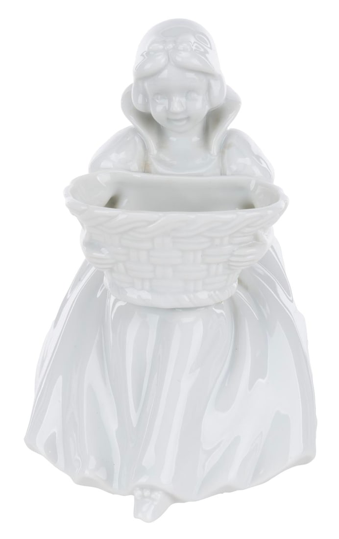 A Tokyo Disneyland Snow White Figurine.: (Tokyo Disneyland, 1980s-90s) A Snow White figurine holding a basket, originally sold at Tokyo Disneyland. Measuring 4" x 3.75" x 5.25" tall, the porcelain figurine is in very good condition with