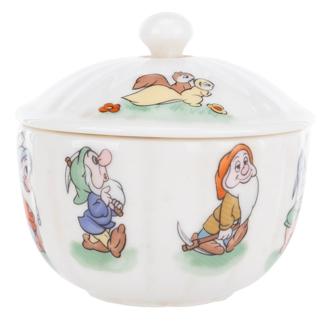 A "Snow White" Ceramic Sugar Bowl.: (Tokyo Disneyland, 1986) A ceramic sugar bowl with lid featuring the seven dwarfs from "Snow White and the Seven Dwarfs." Measuring 4.75" x 4.75" x 3.75", the bowl is in good condition with soiling