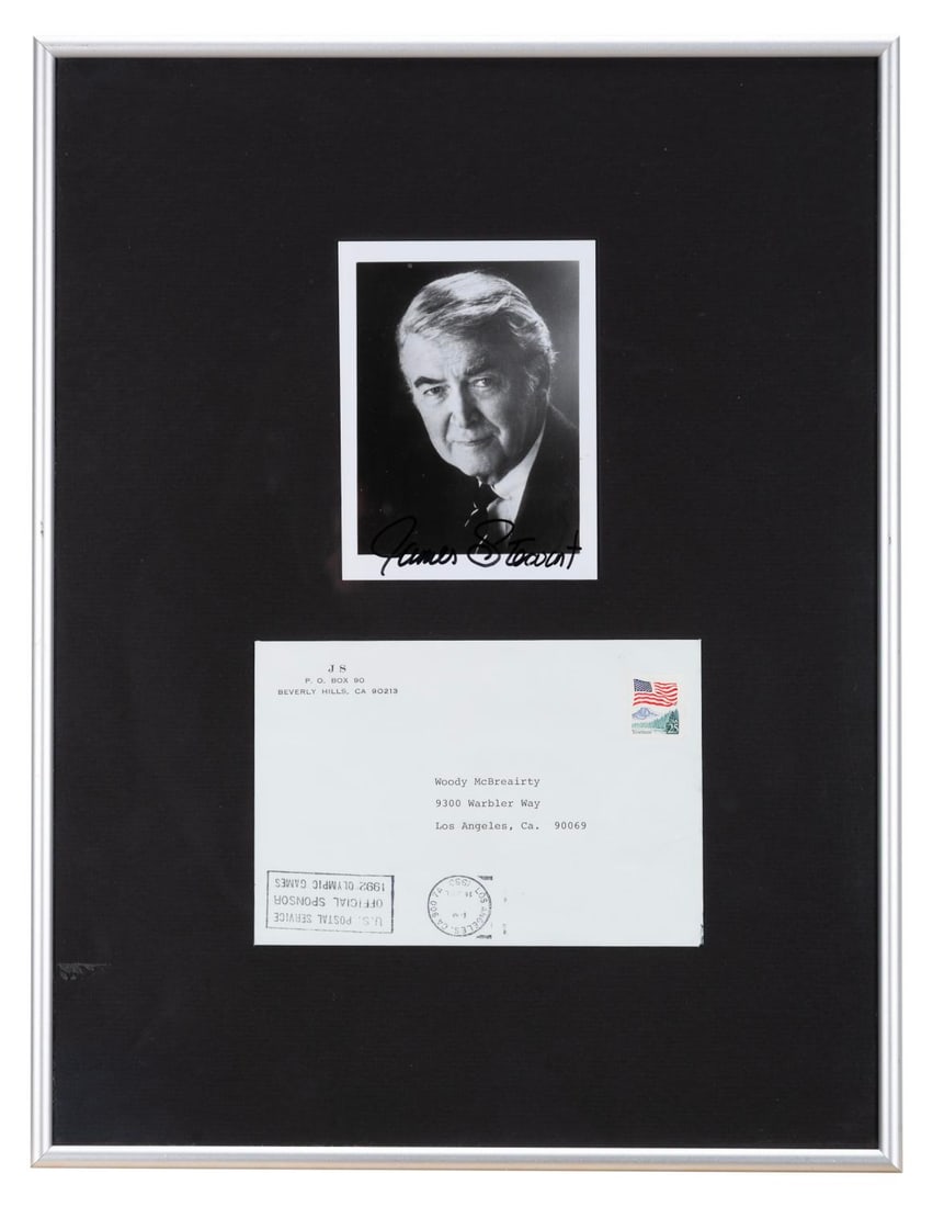 A Jimmy Stewart Signed Photo.: (Stewart, 1990) A signed photo of legendary actor Jimmy Stewart and the envelope he shipped it in. Measuring 4" x 5" and 4.75" x 6.75" in the 13.25" x 17.25" frame, the photo and envelope are in very