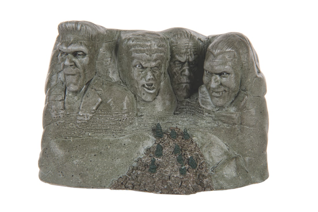 A Universal Studios Classic Monster Mountain Sculpture.: (Sideshow, 1999) A Universal Studios Classic Monster Mountain sculpture featuring Frankenstein, the Wolfman, the Mummy, and Dracula on Mount Rushmore. Measuring 5.25" x 2.5" x 3.5" tall, the