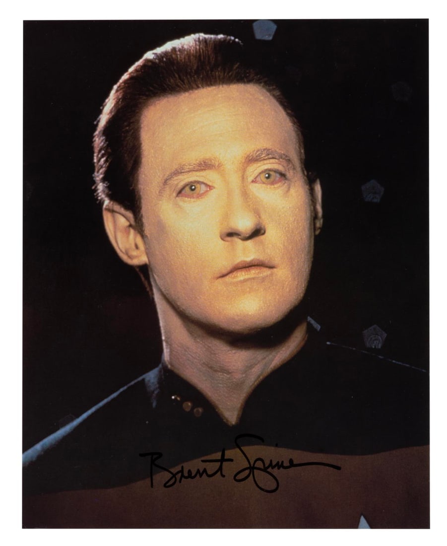 A Brent Spiner Signed "Star Trek: The Next Generation" Photo.: (Paramount, 1990s) An autographed photo/oversized postcard of Brent Spiner as Data in "Star Trek: The Next Generation." Measuring 8" x 10", the signed card is in very good condition with a small creas