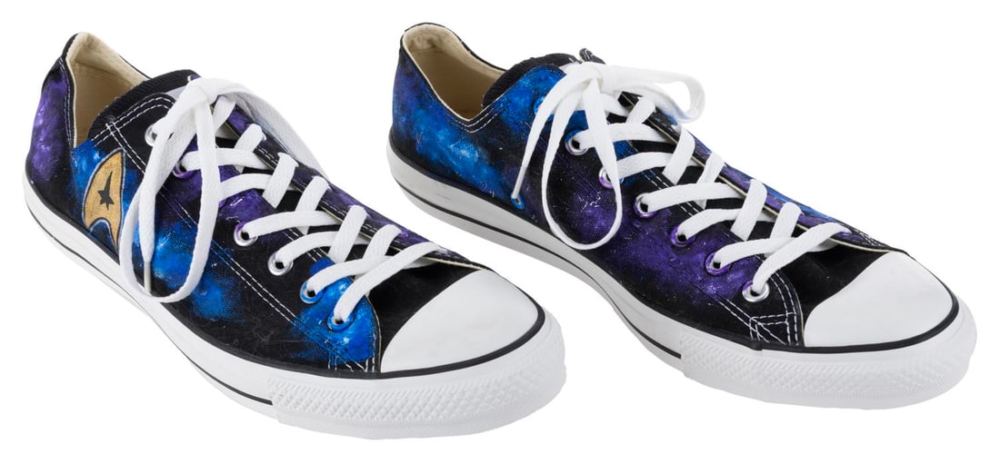A Pair of Star Trek Custom Converse Tennis Shoes.: (Custom Converse, 2000s) A pair of black Converse low-rise sneakers, custom painted by Custom Converse of Cambridge, England, with a Star Trek design. Labeled a size 12, the sneakers are in very good