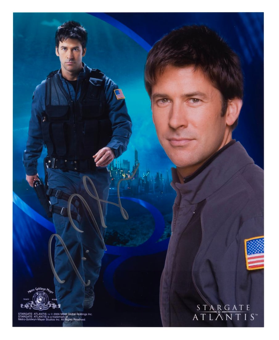 A Joe Flanigan Signed "Stargate Atlantis" Photograph.: (MGM, 2000s) An autographed photograph of Joe Flanigan as Lt. Colonel John Sheppard in Stargate Atlantis. Measuring 8" x 10", the signed photo is in very good condition.