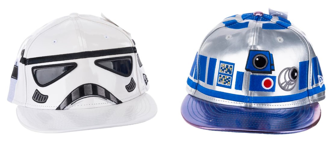 A Pair of Disney Parks Star Wars Caps.: (Disney Parks, 2015) Two Star Wars caps sold at the Disney Parks, in Stormtrooper and R2-D2 designs. Each labeled a size 7 and a half, the caps are in very good condition with light wear, including a 