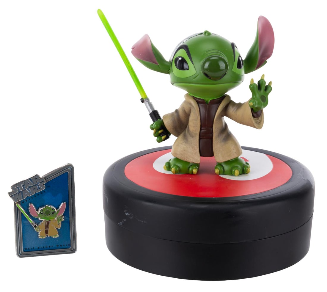 A Star Wars Stitch as Yoda Medium Fig with Pin.: (Walt Disney World, 2013), A Medium Fig of Stitch as Yoda, released exclusively during Star Wars Weekends at Walt Disney World in a limited edition of 1977. Included in the base is a pin of Stitch as 