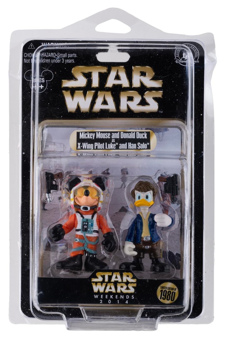 A Pair of Mickey Mouse and Donald Duck Star Wars Figures.: (Walt Disney World, 2014) An action figure set of Mickey Mouse as Luke Skywalker and Donald Duck as Han Solo, as they appeared in "The Empire Strikes Back." The set was released exclusively at Star Wa