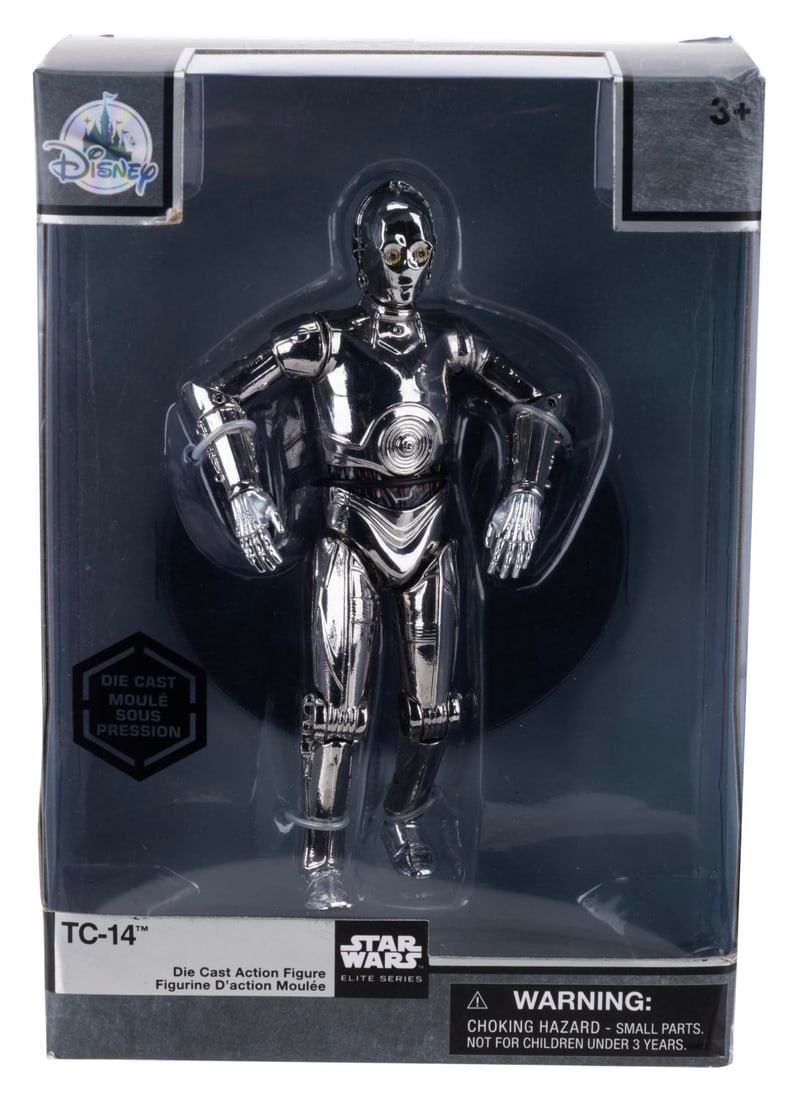 A Disney Parks Star Wars TC-14 Die-Cast Figure.: (Disney Parks, 2019) A die-cast action figure of the Star Wars Elite Series droid TC-14, originally sold in the Disney Parks. Measuring 6" tall in its 5.5" x 3" x 8" tall original packaging, the seale