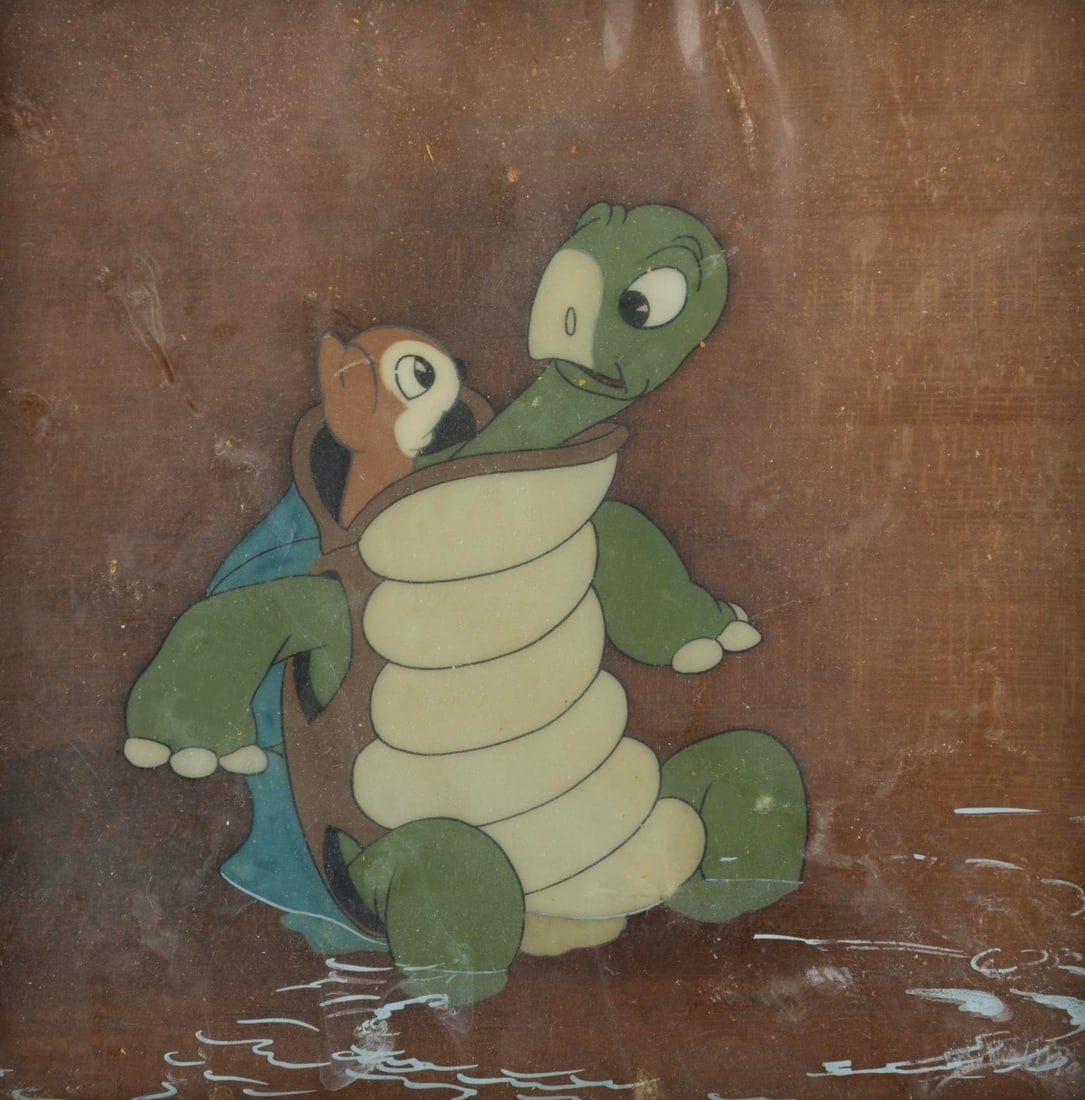 A "Snow White and the Seven Dwarfs" Original Production Cel.: (Disney, 1937) An original production cel of a turtle and chipmunk from Disney's "Snow White and the Seven Dwarfs." The cel has been trimmed to 6" x 6" and placed on a woodgrain background as prepared