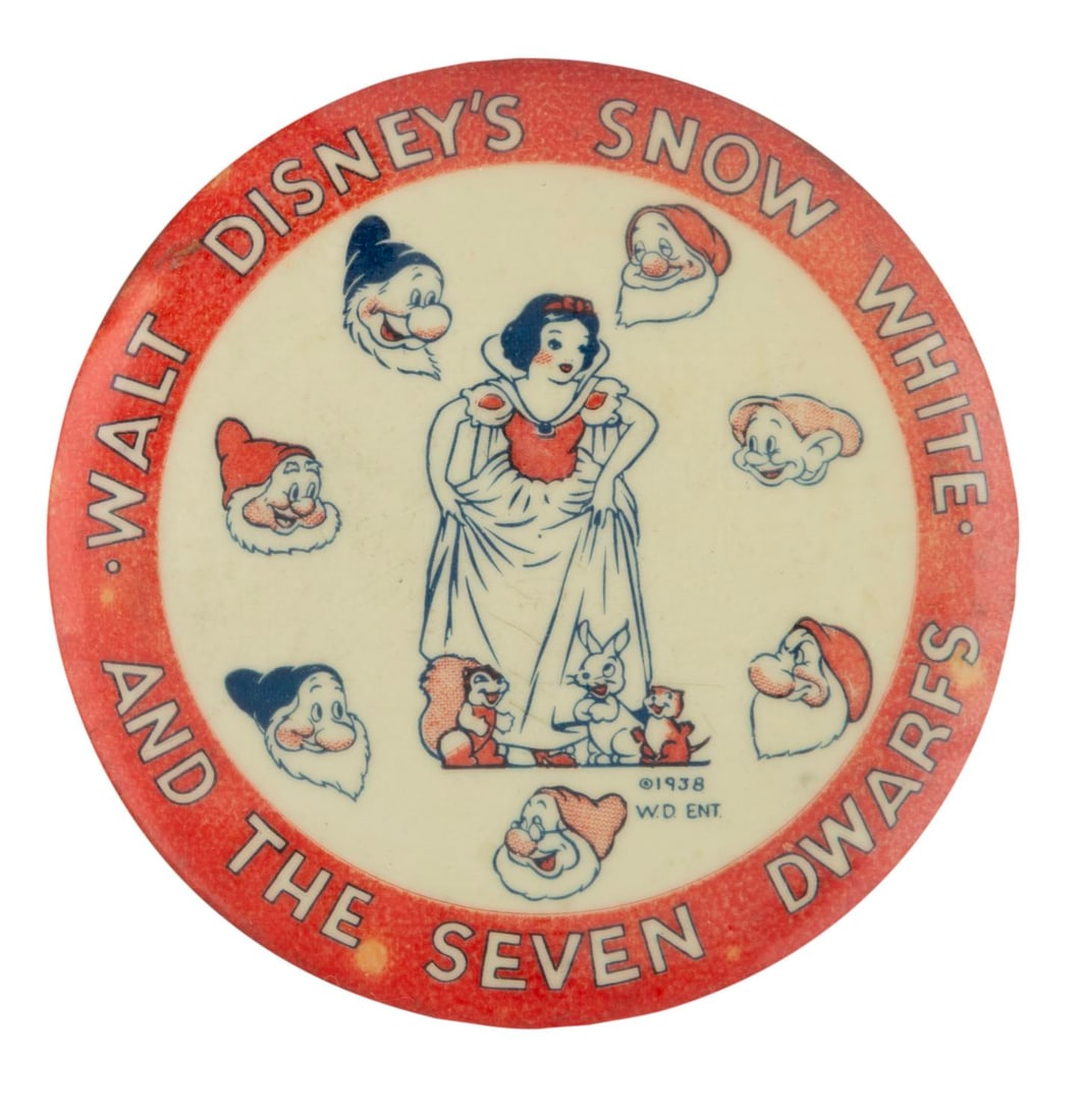 An Early "Snow White" Pinback Button.: (Disney, 1930s/40s) A large early pinback button featuring Snow White and the seven Dwarfs. Measuring 3.5" in diameter, the button is in very good condition with wear from use and age.