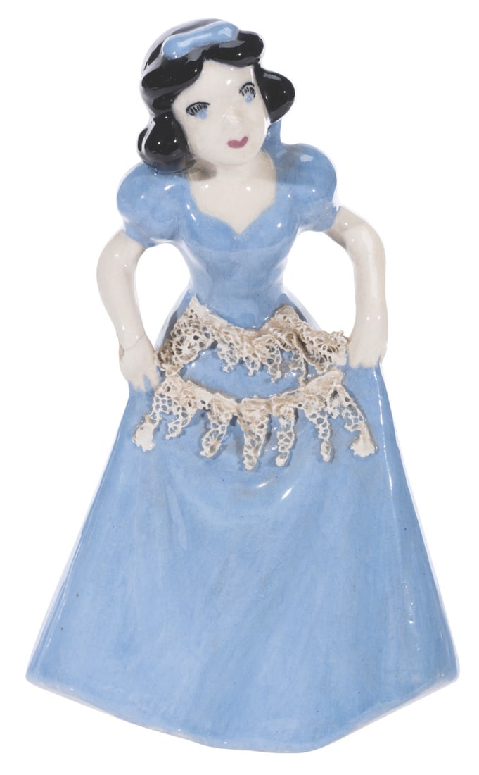 A Snow White Ceramic Figurine.: (Shaw, 1940s) A unique Snow White figurine by Evan K. Shaw, with a custom paint color and apron pieces attached to the front. Measuring 5" x 4.5" x 8.25" tall, the figurine is in fair condition with c